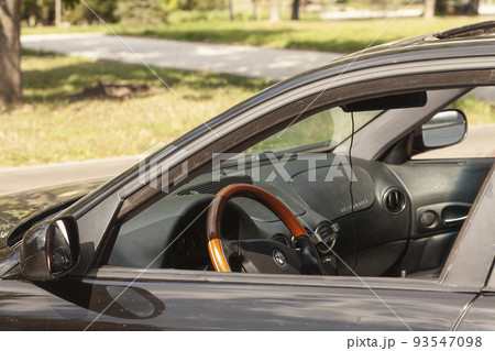 black car with wooden steering wheel black car with wooden steering wheel 93547098