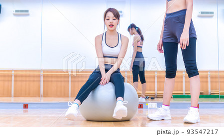 バランスボールに挑戦する若い女性 バランスボールに挑戦する若い女性 93547217