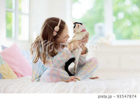 Child playing with baby cat. Kid and kitten. Child playing with baby cat. Kid and kitten. 93547874