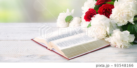 Bible and a bouquet of peonies on a table Bible and a bouquet of peonies on a table 93548166