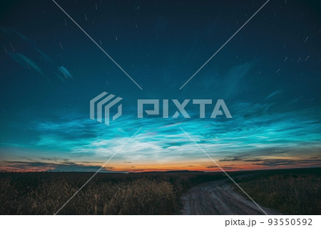 Amazing Rotate Stars Effect In Sky. Soft Colors. 6k Unusual Cloud And Stars Effects Above Countryside Rural Field Landscape With Young Wheat Sprouts. Night Blue Sky. , 93550592