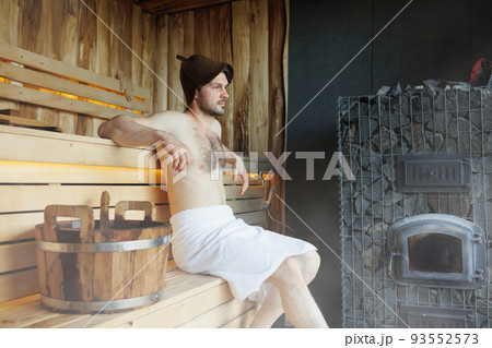 Man in finnish sauna sweating and relaxing 93552573