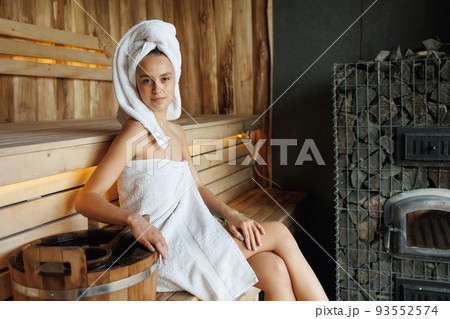 Pretty woman in wooden sauna 93552574