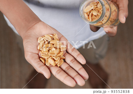 young men eating peanuts top view young men eating peanuts top view 93552838