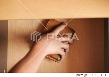 men stealing wallet from a drawer men stealing wallet from a drawer 93553161