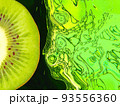 Half of ripe green kiwi slice on green abstract liquid background. 93556360
