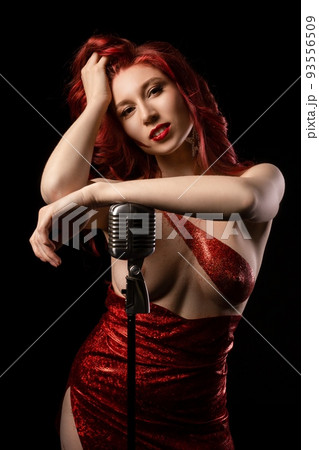 Alluring topless lady standing near microphone on stage and smiling 93556509