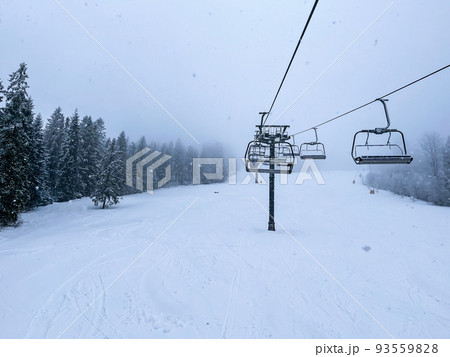 Ski Lift snowy mountain winter forest with chair lift At The Ski Resort in winter. Snowy weather Ski holidays Winter sport and outdoor activities Outdoor tourism Ski Lift snowy mountain winter forest with chair lift At The Ski Resort in winter. Snowy weather Ski holidays Winter sport and outdoor activities Outdoor tourism 93559828