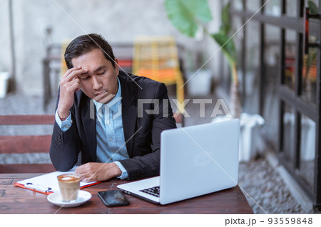frustrated young businessman while working with his laptop frustrated young businessman while working with his laptop 93559848