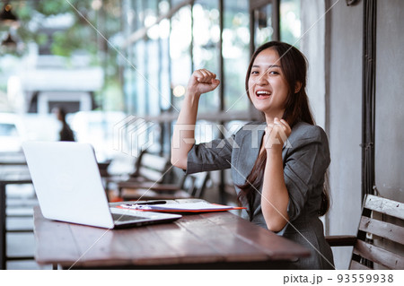 happy excited young business woman while working and using her phone. happy excited young business woman while working and using her phone. 93559938