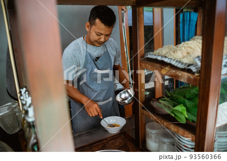 man seller stir vegetable oil in the bowl man seller stir vegetable oil in the bowl 93560366