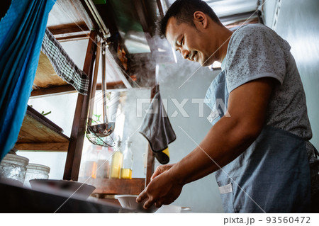 close up of a seller prepares the spices the bowl 93560472