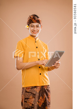 portrait of balinese young man using tablet pc portrait of balinese young man using tablet pc 93560581