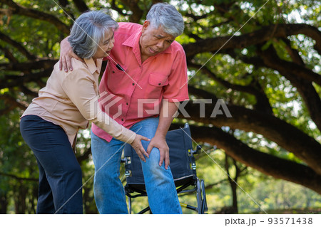 Asian senior man falling down on lying floor at park after Stumbled  and Crying in pain and him wife came to help support. Concept of old elderly insurance and health care 93571438