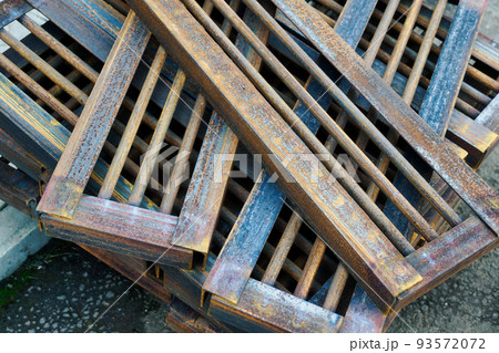 Many identical metal blanks lie in stack. Metal product top view. Industrial manufacturing Many identical metal blanks lie in stack. Metal product top view. Industrial manufacturing 93572072