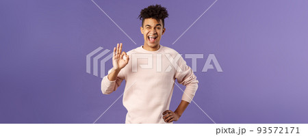 Portrait of enthusiastic young relaxed man show no problem, guarantee gesture, recommend awesome courses where you easily learn new languages, smiling and show ok to assure you Portrait of enthusiastic young relaxed man show no problem, guarantee gesture, recommend awesome courses where you easily learn new languages, smiling and show ok to assure you 93572171