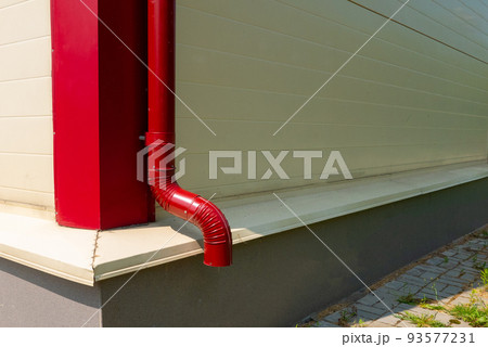 Red gutter on the roof top of house. Red gutter on the roof top of house. 93577231
