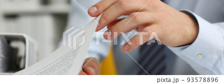 Male hands hold documents with financial statistics in closeup 93578896