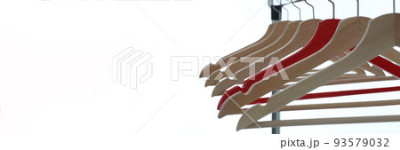Red and wooden hanger hanging from metal pipe Red and wooden hanger hanging from metal pipe 93579032