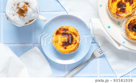 Portuguese dessert Pastel de nata with coffee on blue tile 93581039