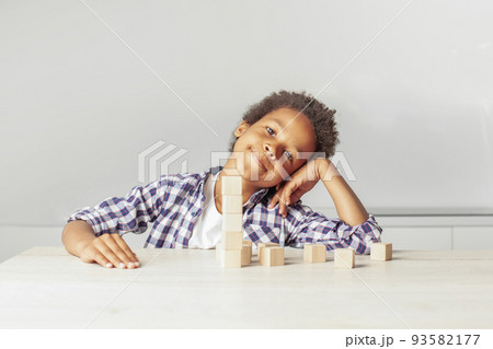 Happy young boy playing and looking at camera at home 93582177