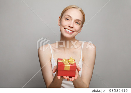 Fashion woman with red gift box having fun. Happy healthy surprised model Fashion woman with red gift box having fun. Happy healthy surprised model 93582416