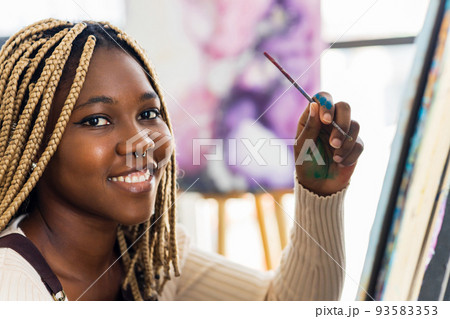 african american woman student in art class inspired and painting 93583353