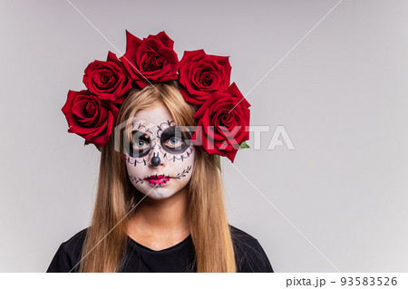 girl with painted face looking at camera in studio and ready to party 93583526