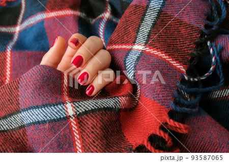 Stylish red female nails. Modern Beautiful manicure. Autumn winter nail design concept of beauty treatment. Gel nails. Skin care. Stylish red female nails. Modern Beautiful manicure. Autumn winter nail design concept of beauty treatment. Gel nails. Skin care. 93587065