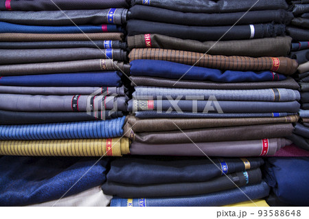 Patterned Textile Fabrics stacked on a retail Shop Shelf for sale Patterned Textile Fabrics stacked on a retail Shop Shelf for sale 93588648