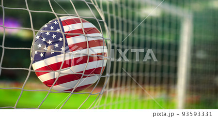Football ball with flag of USA in the net of goal of football stadium. Football championship of United States concept. Football ball with flag of USA in the net of goal of football stadium. Football championship of United States concept. 93593331