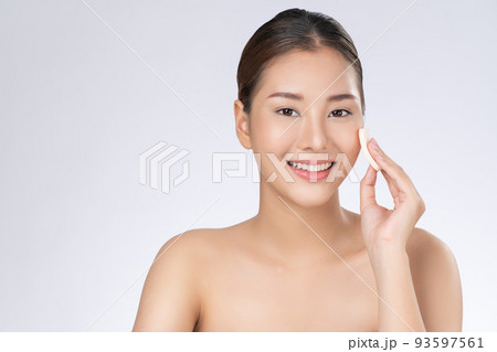 Gorgeous woman applying her cheek with dry powder. 93597561