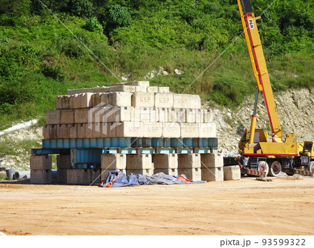 SELANGOR, MALAYSIA -JULY 21, 2020: Construction workers stacking the maintain load test block also known as MLT test at the construction site. The block used to test piling integrity.  93599322