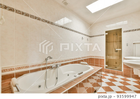 Stylish bathroom interior design with white toilet and bathtub with glass shower in modern apartment Stylish bathroom interior design with white toilet and bathtub with glass shower in modern apartment 93599947