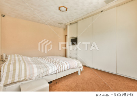 Comfortable bed and soft carpet in spacious bedroom with interior in minimal style Comfortable bed and soft carpet in spacious bedroom with interior in minimal style 93599948