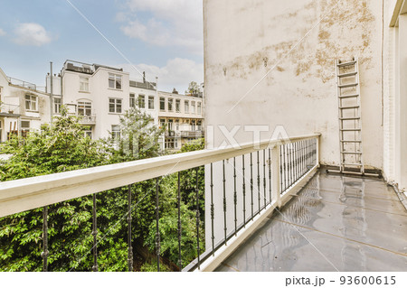 Narrow brick balcony with metal railings and door Narrow brick balcony with metal railings and door 93600615