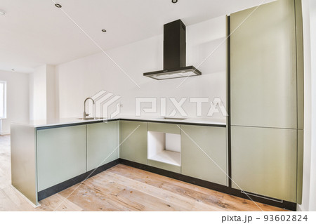 Interior of empty white kitchen with windows and wooden parquet floor 93602824