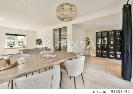 Interior of living room with comfortable sofa and TV against windows in contemporary apartment Interior of living room with comfortable sofa and TV against windows in contemporary apartment 93603446