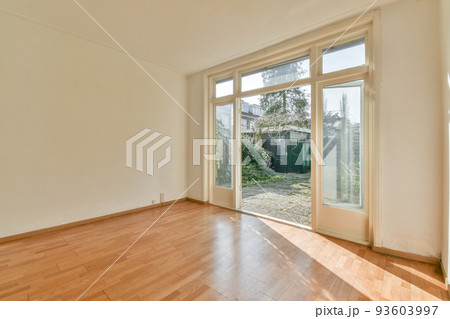Modern counters with stools placed on wooden floor near electric fireplace in spacious room with white walls 93603997