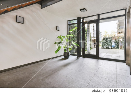 Perspective view of empty narrow hallway with white walls parquet floor in minimalist style apartment 93604812