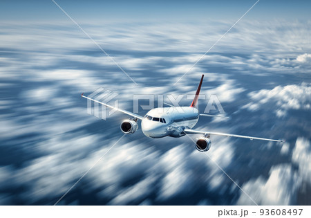 Airplane is flying above the low clouds in summer 93608497