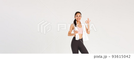 Sport, gym and healthy body concept. Full length of satisfied smiling female athlete, cute asian girl show okay gesture after good fitness training, workout exercises in gym, white background Sport, gym and healthy body concept. Full length of satisfied smiling female athlete, cute asian girl show okay gesture after good fitness training, workout exercises in gym, white background 93615042