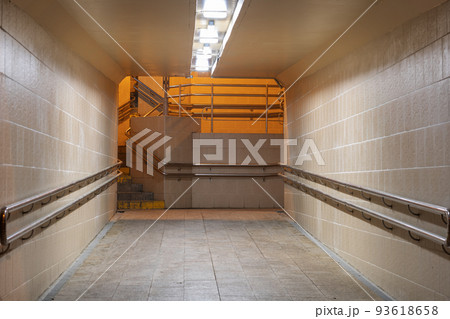 Night glowing underground tunnel. Empty tiled underpass. Modern underground passage glowing at night 93618658
