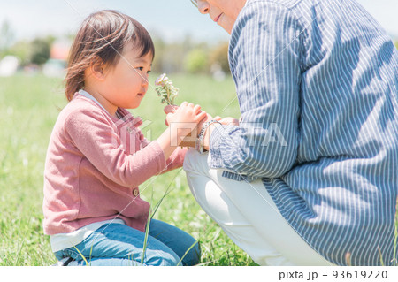 おばあちゃんに花を渡す子供（幼児） 93619220
