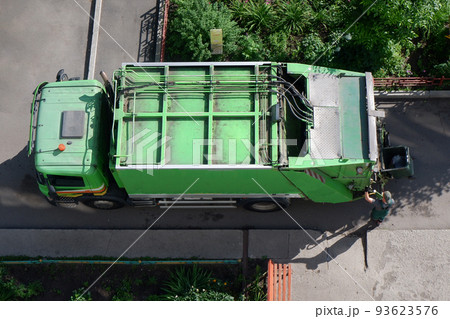 garbage a man loads a garbage truck with garbage. top view garbage a man loads a garbage truck with garbage. top view 93623576