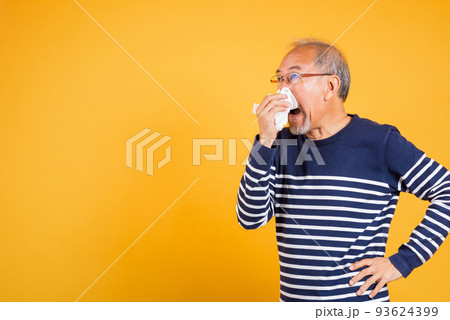 Asian elder man cold having flu and sneezing from sickness virus problem use tissue 93624399