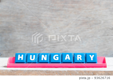 Tile alphabet letter with word hungary in red color rack on wood background 93626716