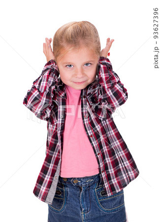 girl covers her ears. The studio shot a portrait of a thoughtful little girl who covers her ears. Copy space on white background. girl covers her ears. The studio shot a portrait of a thoughtful little girl who covers her ears. Copy space on white background. 93627396