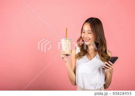 woman holding drinking brown sugar flavored tapioca pearl bubble milk tea 93628455