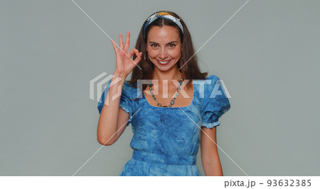 Lovely woman looking approvingly at camera showing ok gesture, like sign positive, approve good Lovely woman looking approvingly at camera showing ok gesture, like sign positive, approve good 93632385